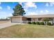 Charming single-story home featuring a well-maintained lawn, mature landscaping, and an attached two-car garage at 18018 N Highwood Ct, Sun City, AZ 85373