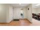 Bright foyer featuring wood floors, a white front door, and an open view into the dining area at 18018 N Highwood Ct, Sun City, AZ 85373