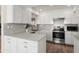 Modern kitchen features white cabinets, stainless steel appliances, and a large island at 18018 N Highwood Ct, Sun City, AZ 85373