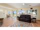 Open living area featuring wood floors, recessed lighting, and a comfortable leather reclining couch at 18018 N Highwood Ct, Sun City, AZ 85373