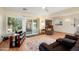 Cozy living area with sleek wood floors, a comfortable recliner, and views of a sunroom and kitchen at 18018 N Highwood Ct, Sun City, AZ 85373