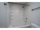 Bright bathroom featuring a tub with tile surround and built in shelving at 18250 N Cave Creek Rd # 164, Phoenix, AZ 85032