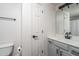 Bathroom featuring gray cabinets, a white sink, mirror, black fixtures, and a toilet at 18250 N Cave Creek Rd # 164, Phoenix, AZ 85032