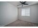 A simple bedroom with neutral paint, carpet and a ceiling fan at 18250 N Cave Creek Rd # 164, Phoenix, AZ 85032