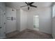 Bright bedroom featuring a ceiling fan and a view of the en-suite bathroom at 18250 N Cave Creek Rd # 164, Phoenix, AZ 85032