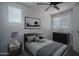 Staged bedroom with window, neutral gray walls, wood accents, carpeted floors and modern decor at 18250 N Cave Creek Rd # 164, Phoenix, AZ 85032