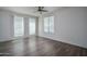 Bright, empty bedroom with hardwood floors, ceiling fan, and natural light from large window at 18250 N Cave Creek Rd # 164, Phoenix, AZ 85032