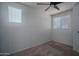 Unfurnished bedroom with carpeted floors, two windows, ceiling fan, and ample natural light at 18250 N Cave Creek Rd # 164, Phoenix, AZ 85032