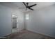Unfurnished bedroom with walk-in closet, ceiling fan, and carpeted floors at 18250 N Cave Creek Rd # 164, Phoenix, AZ 85032
