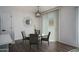 Cozy dining area with a glass table, four chairs, and a modern chandelier at 18250 N Cave Creek Rd # 164, Phoenix, AZ 85032