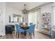 Cozy dining area featuring a round table with stylish blue chairs and a decorative lighting fixture at 18250 N Cave Creek Rd # 164, Phoenix, AZ 85032