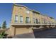 Multi-story townhomes with private garages and balconies on a sunny day at 18250 N Cave Creek Rd # 164, Phoenix, AZ 85032