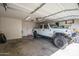 Spacious garage featuring a white Jeep Gladiator, shelving, and an insulated garage door at 18250 N Cave Creek Rd # 164, Phoenix, AZ 85032