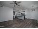 Open concept kitchen with stainless steel appliances, island, and dining space, featuring hardwood floors at 18250 N Cave Creek Rd # 164, Phoenix, AZ 85032