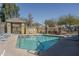 Community pool surrounded by lounge chairs, fencing, and desert landscaping at 18250 N Cave Creek Rd # 164, Phoenix, AZ 85032