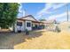 The backyard features a covered patio, chicken coop and lush greenery, offering ample space for outdoor living at 18435 N 36Th Ave, Glendale, AZ 85308