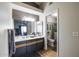 Bathroom features a vanity with ample storage, a framed mirror, and a glass-enclosed shower at 18435 N 36Th Ave, Glendale, AZ 85308