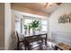 Cozy dining area featuring a sunny bay window, wood floors, and a ceiling fan for added comfort at 18435 N 36Th Ave, Glendale, AZ 85308