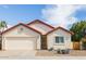 Charming home featuring a neutral stucco facade, red tile roof, and a well-manicured front yard at 18435 N 36Th Ave, Glendale, AZ 85308