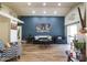 Spacious living room showcasing a blue accent wall, recessed lighting, and wood-look tile flooring at 18435 N 36Th Ave, Glendale, AZ 85308