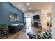 Bright living room featuring a decorative fireplace, a TV, and sliding glass doors for ample natural light at 18435 N 36Th Ave, Glendale, AZ 85308