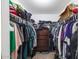 Walk-in closet with ample storage and organization options, including hanging racks and drawers at 18435 N 36Th Ave, Glendale, AZ 85308