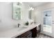 Bright bathroom featuring double sinks, quartz counters, and a glass-enclosed shower at 1847 W Isleta Ave, Mesa, AZ 85202