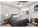 This bedroom features a ceiling fan, window and hardwood floors at 1847 W Isleta Ave, Mesa, AZ 85202