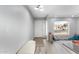 Bright entryway features light gray walls and flooring, a bench, and a sidelight next to the front door at 1847 W Isleta Ave, Mesa, AZ 85202