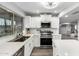 Modern kitchen featuring stainless steel appliances, white cabinetry, and an undermount sink with backyard view at 1847 W Isleta Ave, Mesa, AZ 85202