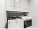 This laundry room features a modern washer and dryer and ample overhead cabinet space at 1847 W Isleta Ave, Mesa, AZ 85202