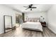 Calm main bedroom with a view to the backyard, featuring a ceiling fan and wood-look floors at 1847 W Isleta Ave, Mesa, AZ 85202