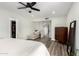 Bright bedroom featuring wood-look floors, a ceiling fan, a chaise lounge, and a built-in closet at 1847 W Isleta Ave, Mesa, AZ 85202