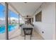 An outdoor covered patio features a ceiling fan, lights, and dining table, with a pool view, perfect for relaxation at 1847 W Isleta Ave, Mesa, AZ 85202