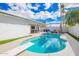 A backyard oasis featuring a diving board and pool, complete with a covered patio and outdoor dining area at 1847 W Isleta Ave, Mesa, AZ 85202