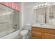 Traditional bathroom featuring a shower with a glass door, tile floors, and wood cabinets at 20029 N Coronado Ridge Dr, Surprise, AZ 85387