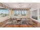 Bright and airy living room featuring hardwood floors and large windows with desert landscape views at 20029 N Coronado Ridge Dr, Surprise, AZ 85387