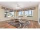 Light-filled living room with hardwood flooring and views of the meticulously maintained backyard at 20029 N Coronado Ridge Dr, Surprise, AZ 85387