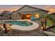 Outdoor living space featuring a pool with a waterfall, lounge chairs, lush landscaping and covered patio at 20102 E Robin Rd, Queen Creek, AZ 85142