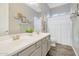 Bathroom with dual sinks, modern fixtures, and a shower behind a white shower curtain at 20102 E Robin Rd, Queen Creek, AZ 85142