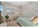 Bright bedroom featuring a modern desk, and a comfortable bed with a pastel blue comforter at 20102 E Robin Rd, Queen Creek, AZ 85142