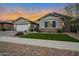 Well-maintained single-Gathering home showcasing a green lawn and lovely sunset sky in a great neighborhood at 20102 E Robin Rd, Queen Creek, AZ 85142