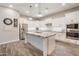 Bright kitchen with white cabinetry, granite countertops, stainless steel appliances and stylish pendant lighting at 20102 E Robin Rd, Queen Creek, AZ 85142