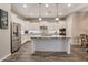 Modern kitchen with white cabinets, stainless steel appliances, granite countertops, and a central island at 20102 E Robin Rd, Queen Creek, AZ 85142