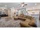 Spacious living room with hardwood floors, a ceiling fan and plenty of natural light at 20102 E Robin Rd, Queen Creek, AZ 85142