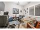 Well-lit home office with a large desk, comfortable chairs, and sports memorabilia on display at 20102 E Robin Rd, Queen Creek, AZ 85142