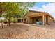 Backyard featuring decorative rock and a covered patio at 213 S 225Th Ln, Buckeye, AZ 85326