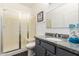 Bathroom featuring glass enclosed shower and granite vanity at 213 S 225Th Ln, Buckeye, AZ 85326