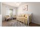 Well-lit bedroom with a cozy daybed, natural light, and neutral decor at 213 S 225Th Ln, Buckeye, AZ 85326