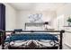 Bedroom featuring decorative metal frame bed with white bedding and blue accents at 213 S 225Th Ln, Buckeye, AZ 85326